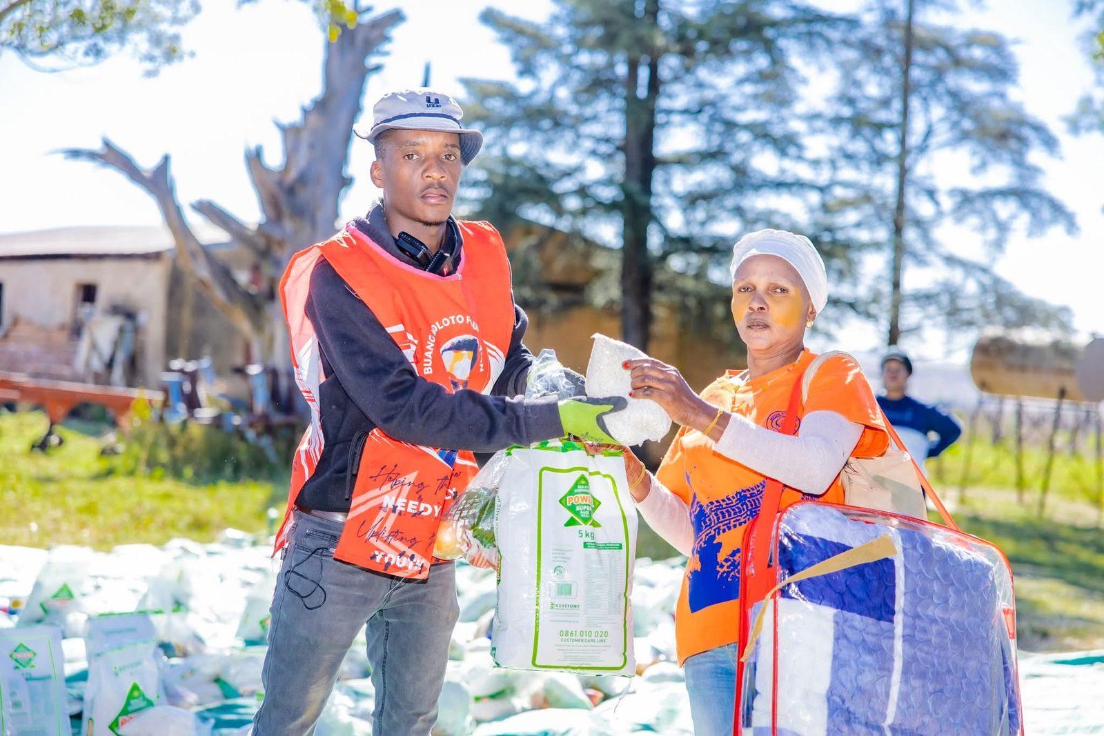 Volunteer handing over relief goods